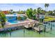 Aerial view of pool and private dock with boat lift on waterfront home at 403 Normandy Rd, Madeira Beach, FL 33708