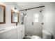 Modern bathroom featuring a glass walk-in shower and updated vanity with framed mirrors at 403 Normandy Rd, Madeira Beach, FL 33708