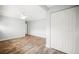 Bright bedroom featuring hardwood floors, a ceiling fan, and a spacious closet for ample storage at 403 Normandy Rd, Madeira Beach, FL 33708