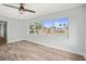 Bedroom featuring durable floors and a bright window with views of the pool and waterfront at 403 Normandy Rd, Madeira Beach, FL 33708