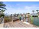 Private dock with lift, storage, and railing provides direct access to the beautiful waterfront at 403 Normandy Rd, Madeira Beach, FL 33708