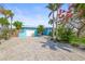 Charming waterfront home featuring a well-maintained yard, modern exterior, and paved driveway at 403 Normandy Rd, Madeira Beach, FL 33708