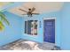 Close-up view of the home's entrance, featuring a modern ceiling fan and a stylish, newly painted front door at 403 Normandy Rd, Madeira Beach, FL 33708