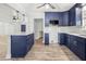 Bright open kitchen with dark blue cabinets, stainless appliances and white countertops at 403 Normandy Rd, Madeira Beach, FL 33708