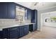 Beautiful kitchen featuring dark blue cabinets and stainless steel fixtures at 403 Normandy Rd, Madeira Beach, FL 33708