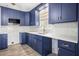 Stylish kitchen with dark blue cabinets, white countertops, mosaic backsplash and gold hardware at 403 Normandy Rd, Madeira Beach, FL 33708