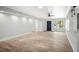 Expansive living area featuring sleek wood-look tile, neutral walls, and a modern ceiling fan providing both style and comfort at 403 Normandy Rd, Madeira Beach, FL 33708