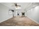 Spacious living room with wood-look tile floors, a stone fireplace, and an open view to the kitchen and front entry at 403 Normandy Rd, Madeira Beach, FL 33708
