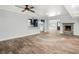 Bright and airy living space with wood-look tile floors, stone fireplace, and seamless flow into the kitchen and dining areas at 403 Normandy Rd, Madeira Beach, FL 33708