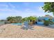 Spacious patio with waterfront views, mature palms, and a refreshing pool at 403 Normandy Rd, Madeira Beach, FL 33708