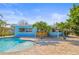 Lovely pool and large brick-paved area with a tiki bar and home painted in cool, light-blue tones at 403 Normandy Rd, Madeira Beach, FL 33708