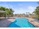 Secluded pool with waterfront views surrounded by mature palms at 403 Normandy Rd, Madeira Beach, FL 33708