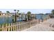 Waterfront access from private walkway, fencing, and lush landscaping at 403 Normandy Rd, Madeira Beach, FL 33708
