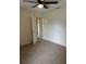 Neutral bedroom with a ceiling fan and doorway to a closet or ensuite bathroom at 5281 Venetian Ne Blvd, St Petersburg, FL 33703