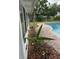 Side view of home's enclosed patio and brick pool surround at 5281 Venetian Ne Blvd, St Petersburg, FL 33703