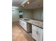 Bright kitchen featuring an island, white cabinets, granite countertops, and stainless steel faucet at 5281 Venetian Ne Blvd, St Petersburg, FL 33703