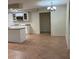 Bright kitchen with a tile floor, breakfast bar, updated appliances and a view of an adjacent open room at 5281 Venetian Ne Blvd, St Petersburg, FL 33703