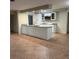Kitchen featuring a large island, white cabinets, granite countertops, and tile flooring at 5281 Venetian Ne Blvd, St Petersburg, FL 33703