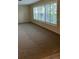 Bright living room featuring neutral carpet and large windows with plantation shutters at 5281 Venetian Ne Blvd, St Petersburg, FL 33703