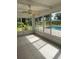 Enclosed patio with tile flooring, ceiling fan, and view of the pool at 5281 Venetian Ne Blvd, St Petersburg, FL 33703