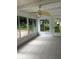 Enclosed patio featuring tile flooring, screened windows, and ceiling fan at 5281 Venetian Ne Blvd, St Petersburg, FL 33703