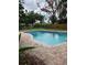 Sparkling in-ground swimming pool with a brick surround in a fenced backyard at 5281 Venetian Ne Blvd, St Petersburg, FL 33703