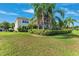 Spacious backyard with lush greenery, mature trees, and a screened-in patio for outdoor enjoyment at 5457 Sandy Shell Dr, Apollo Beach, FL 33572