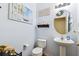 Stylish powder room with pedestal sink and decor at 5457 Sandy Shell Dr, Apollo Beach, FL 33572