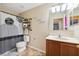 Cozy bathroom with a decorative shower curtain and single sink vanity cabinet at 5457 Sandy Shell Dr, Apollo Beach, FL 33572
