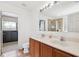 Bathroom featuring a double sink vanity with granite countertops and a large mirror at 5457 Sandy Shell Dr, Apollo Beach, FL 33572