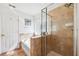 Bright bathroom featuring a tub, glass shower, and tiled accents at 5457 Sandy Shell Dr, Apollo Beach, FL 33572