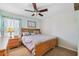 Bedroom with wood bed frame, a ceiling fan, and neutral decor at 5457 Sandy Shell Dr, Apollo Beach, FL 33572