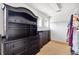 Walk-in closet with black built-in shelving and carpet flooring provides ample storage at 5457 Sandy Shell Dr, Apollo Beach, FL 33572