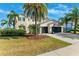 Charming two-story home features lush landscaping, a basketball hoop, and a spacious three-car garage at 5457 Sandy Shell Dr, Apollo Beach, FL 33572
