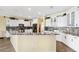 Bright kitchen features granite countertops, white cabinets, and modern appliances at 5457 Sandy Shell Dr, Apollo Beach, FL 33572