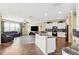 Bright, open kitchen featuring granite countertops, stainless steel appliances, and an island with a sink at 5457 Sandy Shell Dr, Apollo Beach, FL 33572