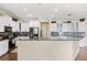 Bright kitchen features granite countertops, white cabinets, and modern appliances at 5457 Sandy Shell Dr, Apollo Beach, FL 33572
