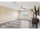 Spacious living room features light yellow walls and gray laminate flooring at 5457 Sandy Shell Dr, Apollo Beach, FL 33572