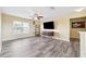 Spacious living room features light yellow walls and gray laminate flooring at 5457 Sandy Shell Dr, Apollo Beach, FL 33572