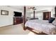 Large main bedroom features a four-poster bed, dresser and an adjacent sitting area at 5457 Sandy Shell Dr, Apollo Beach, FL 33572
