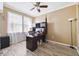 Bright office space with wood-look flooring, a large desk, and natural light from the window at 5457 Sandy Shell Dr, Apollo Beach, FL 33572