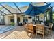 Spacious outdoor patio complete with furniture, grill, and charming brick pavers at 5457 Sandy Shell Dr, Apollo Beach, FL 33572