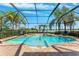 Enclosed pool with brick patio overlooking the lake and providing a tropical feel at 5457 Sandy Shell Dr, Apollo Beach, FL 33572