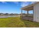 A screened in patio overlooks a lush lawn, lake, and white picket fence at 6211 114Th E Dr, Parrish, FL 34219