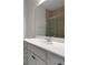 A modern bathroom featuring a white vanity with a quartz countertop and a glass-enclosed shower at 6211 114Th E Dr, Parrish, FL 34219