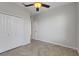 A neutral bedroom featuring a ceiling fan, a closet, and herringbone-patterned floors at 6211 114Th E Dr, Parrish, FL 34219