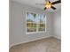 Bright bedroom with a large window, herringbone-patterned floors, and neutral wall color at 6211 114Th E Dr, Parrish, FL 34219