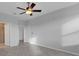 A neutral bedroom featuring a ceiling fan, a closet, and herringbone-patterned floors at 6211 114Th E Dr, Parrish, FL 34219