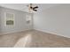 Bright bedroom featuring two windows, herringbone floors, and a ceiling fan at 6211 114Th E Dr, Parrish, FL 34219