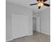 A neutral bedroom featuring a ceiling fan, a closet, and herringbone-patterned floors at 6211 114Th E Dr, Parrish, FL 34219